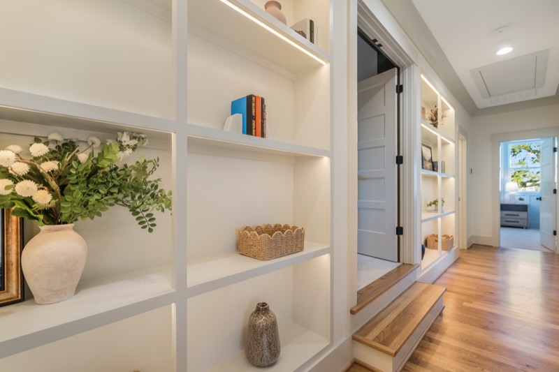 Lit built-in shelves along the hall