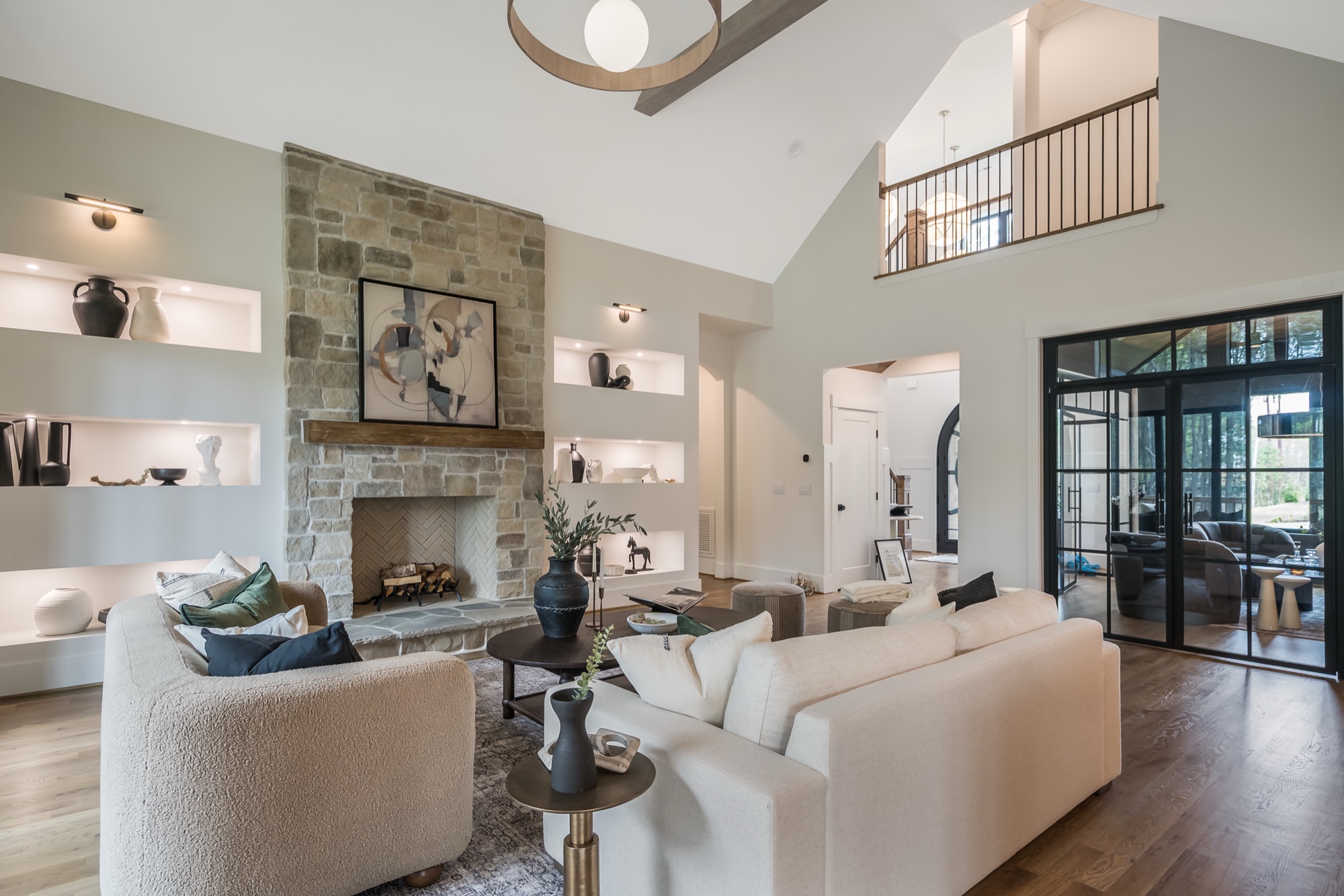 Great room with stone fireplace and lit display niches