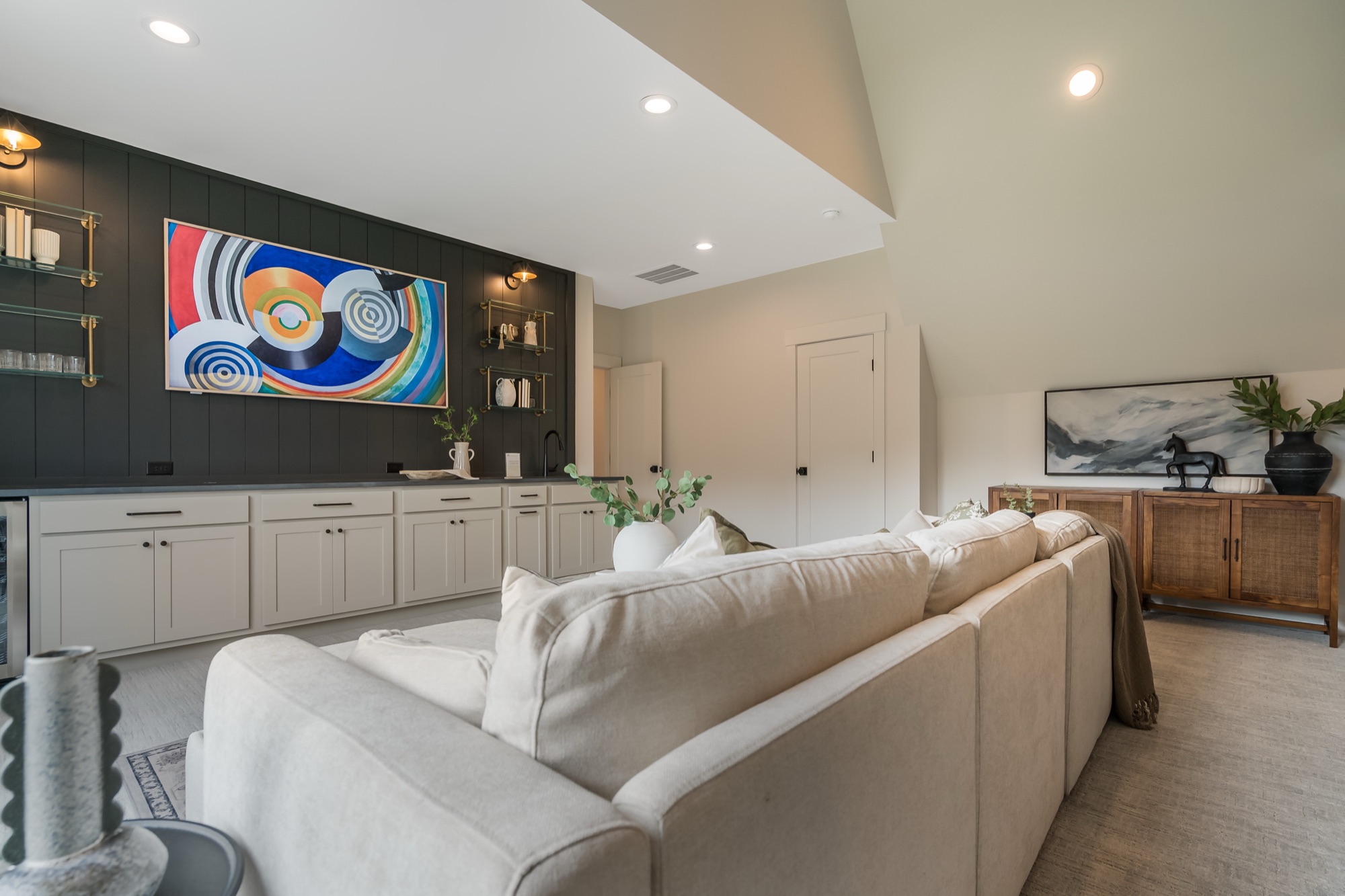 Living room with a shiplap fireplace wall and integrated TV
