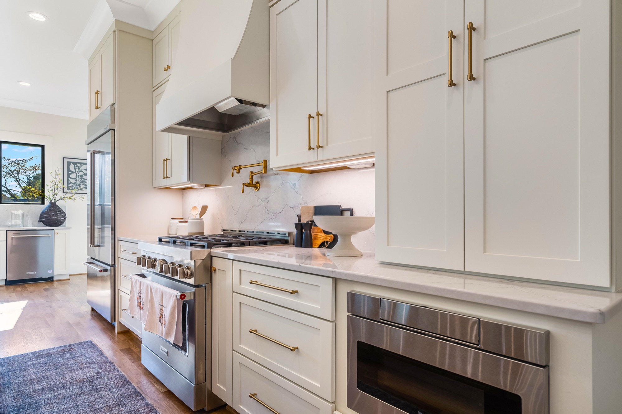 Ivory painted cabinetry with brass hardware