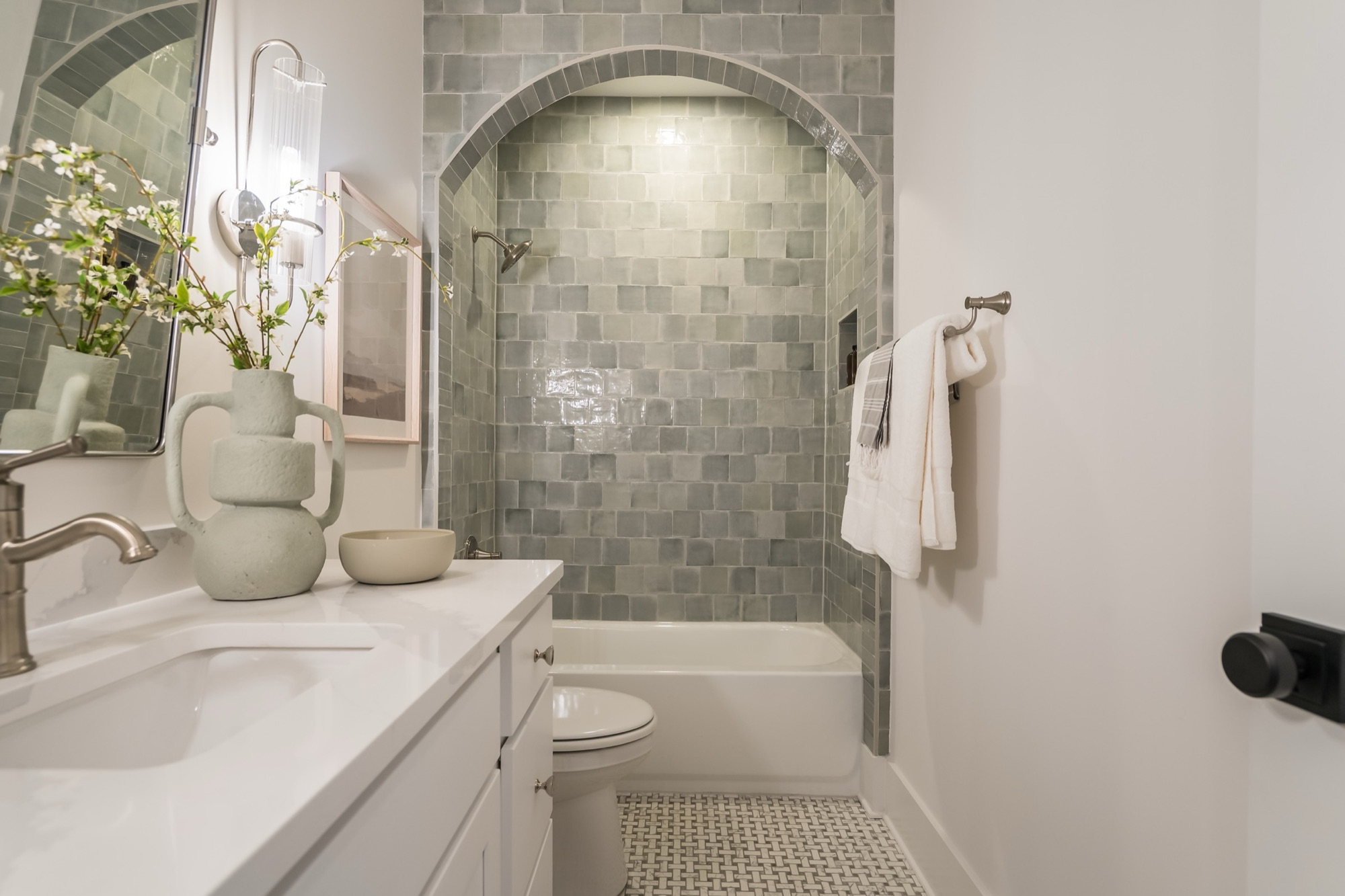 Arched zellige tile shower with styled vase