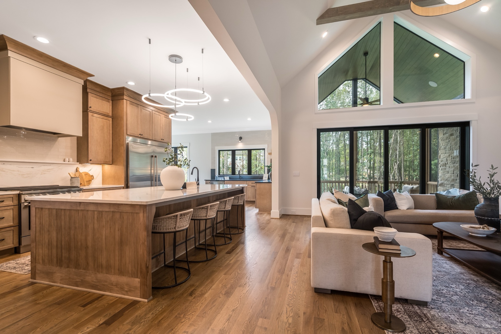Open-plan kitchen and family room with vaulted ceiling and selected finishes