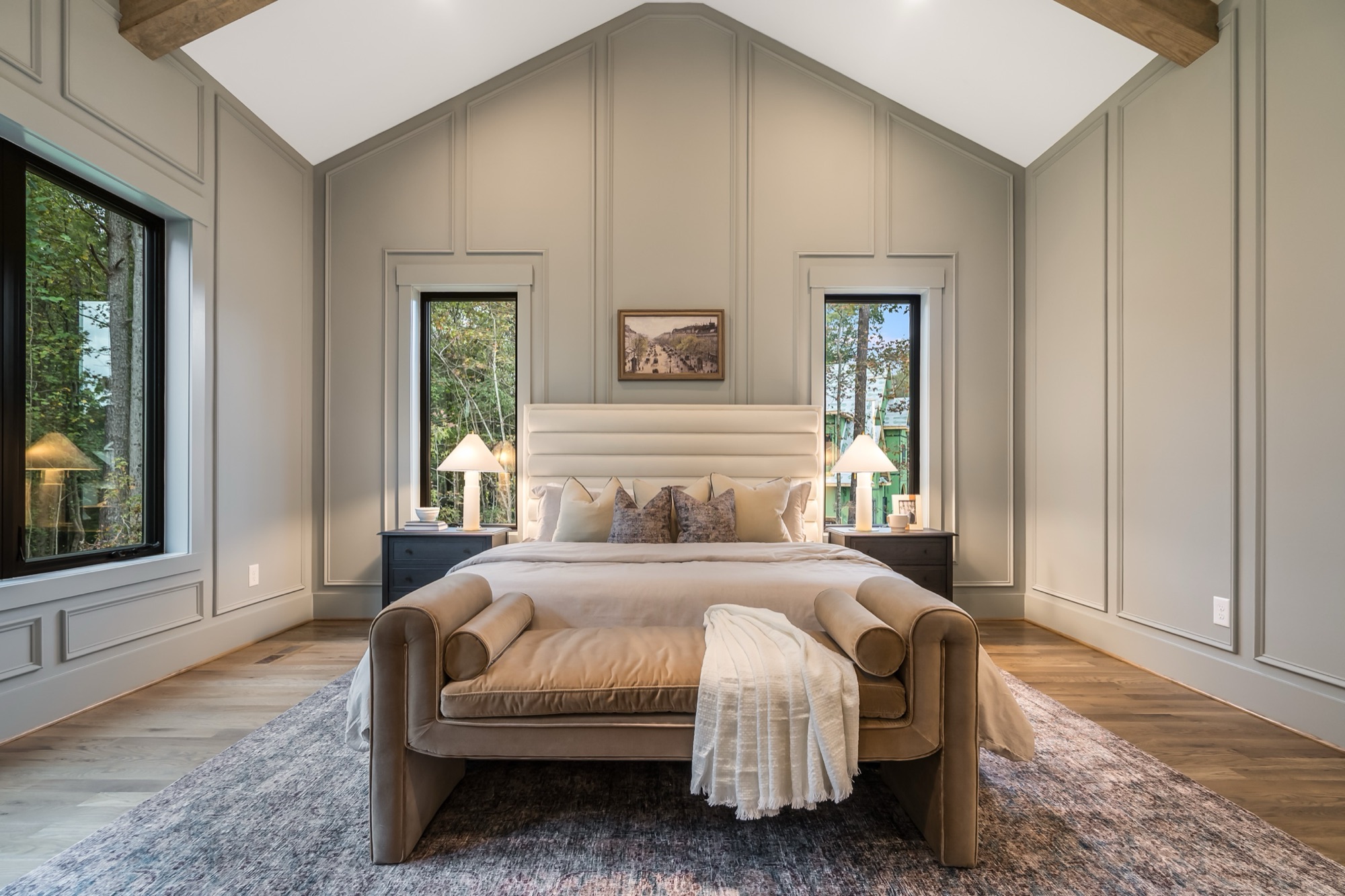 Master bedroom with vaulted ceiling, paneling, and wide-plank hardwood
