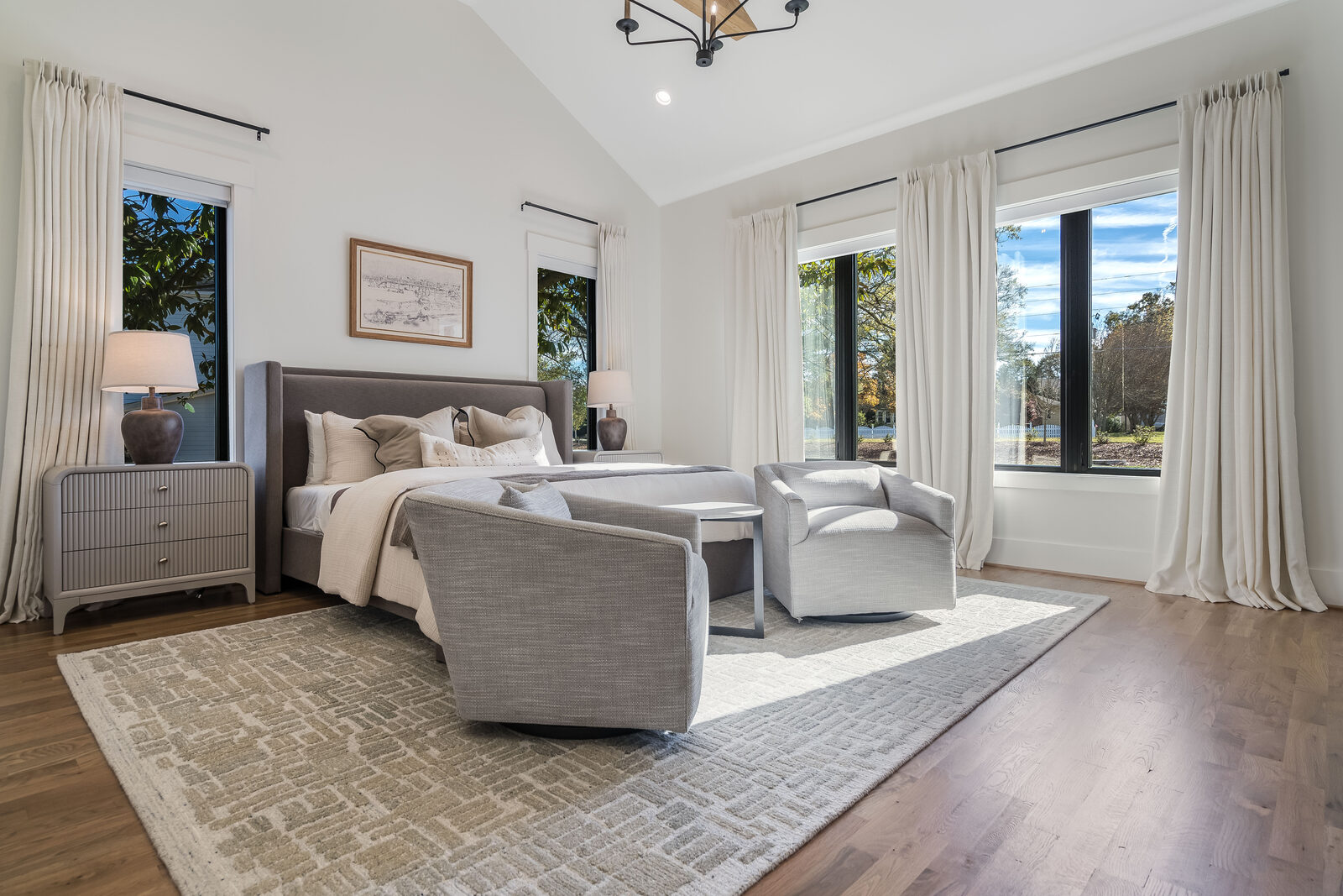 Staged primary bedroom with a vaulted ceiling in a Gemstone custom home