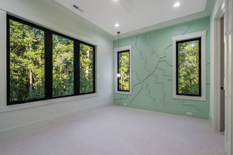 Bedroom with a sculpted sage feature wall in a Gemstone custom home