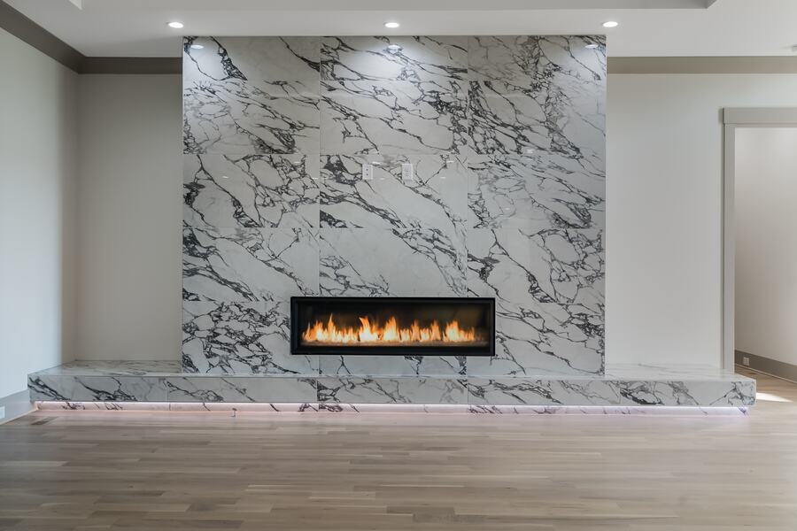 Great room with a full-height marble fireplace wall in a Gemstone custom home