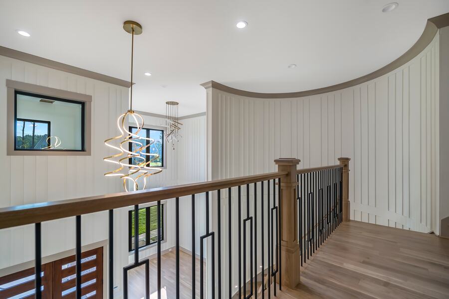 Spiral chandelier in the two-story stair volume of a Gemstone custom home