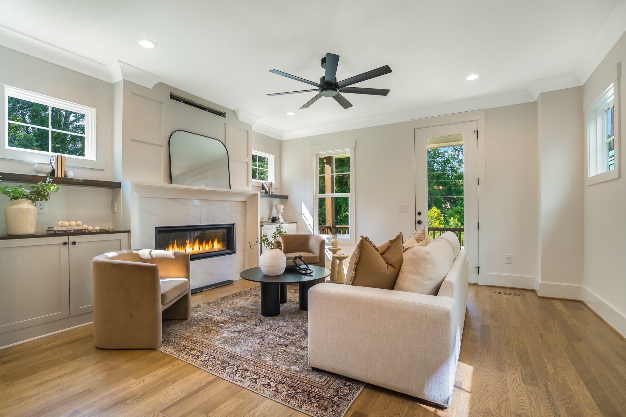 Great room with a linear fireplace in a Gemstone cottage on West Chatham Street in Apex, NC